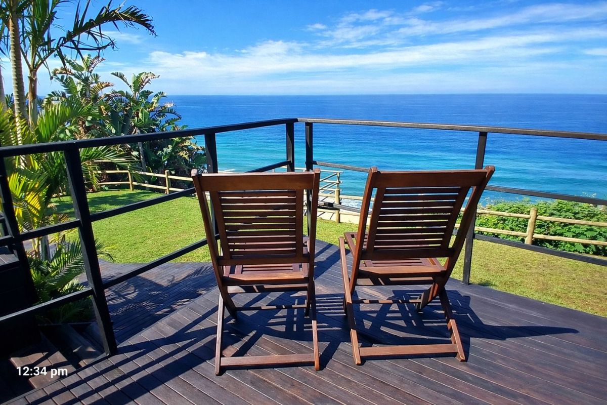 Enjoy panoramic sea views from The Tides Inn on the Bluff, with wooden deck chairs overlooking the bright blue Indian Ocean horizon.
